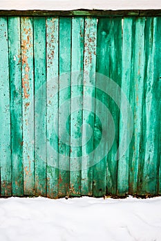 Pelling green paint on wood fence