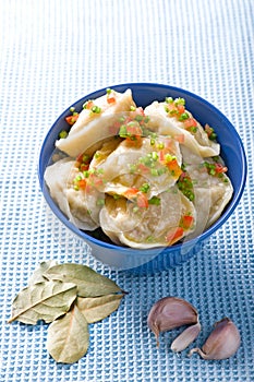 Pelmeni with garlic and bay leaf