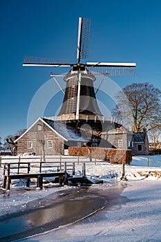 Pelmolen Ter Horst, Rijssen covered in snowy landscape in Overijssel Netherlands, historical wind mill during winter