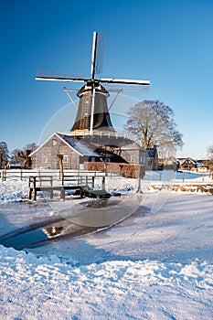 Pelmolen Ter Horst, Rijssen covered in snowy landscape in Overijssel Netherlands, historical wind mill during winter