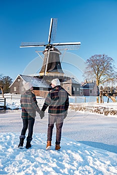 Pelmolen Ter Horst, Rijssen covered in snowy landscape in Overijssel Netherlands, historical wind mill during winter