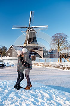 Pelmolen Ter Horst, Rijssen covered in snowy landscape in Overijssel Netherlands, historical wind mill during winter