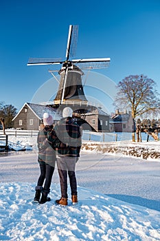 Pelmolen Ter Horst, Rijssen covered in snowy landscape in Overijssel Netherlands, historical wind mill during winter