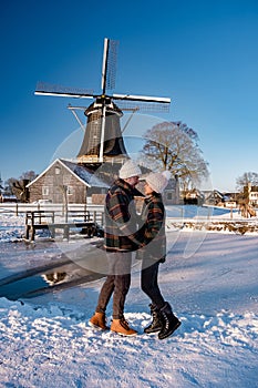 Pelmolen Ter Horst, Rijssen covered in snowy landscape in Overijssel Netherlands, historical wind mill during winter