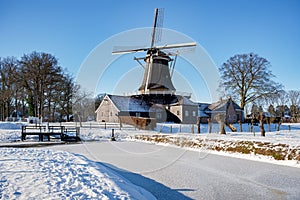 Pelmolen Ter Horst, Rijssen covered in snowy landscape in Overijssel Netherlands, historical wind mill during winter