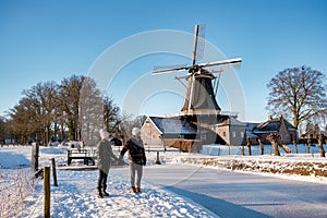 Pelmolen Ter Horst, Rijssen covered in snowy landscape in Overijssel Netherlands, historical wind mill during winter