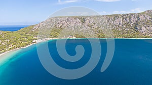Peloponnese, Greece Aerial view on turqouise blue water and sandy beach. Limni Vouliagmeni or Ireon Lake,