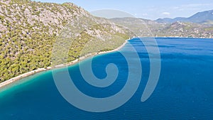 Peloponnese, Greece Aerial view on turqouise blue water and sandy beach. Limni Vouliagmeni or Ireon Lake,