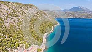 Peloponnese, Greece Aerial view on turqouise blue water and sandy beach. Limni Vouliagmeni or Ireon Lake,