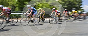 Peloton of bicycle riders in a race in motion
