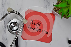 Pelvic Examination write on sticky notes isolated on Wooden Table