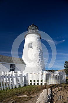 Pemaquid Point Lighthouse above rocky coastal rock formations on