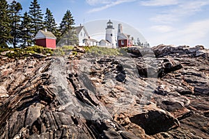 Pemaquid Point Lighthouse and Keepper`s House on a dramatic rocky coast