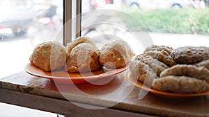 Pempek on a plate at a storefront display case.