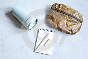 Pen, bag and cardboard cup made of recycled paper. Environmentally stationary