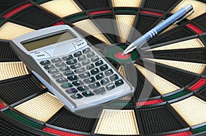 Pen and Calculator over Darts Board