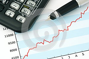 Pen and Calculator on Positive Earning Graph