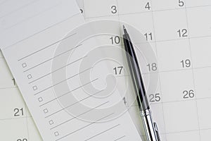 Pen on checklist with checkbox notepad on clean calendar using as special event, planner, important reminder or appointment list