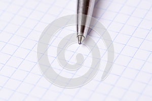 Pen close-up on a notebook isolated on white background