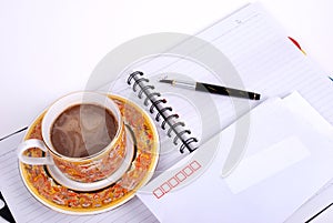 Pen ,coffee and envelop on notebook