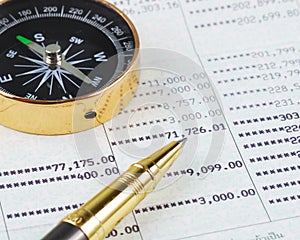 Pen and compass on bank account book