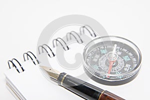 A pen and compass on note book