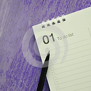 Pen on Fisrt Month To do List on Violet Background