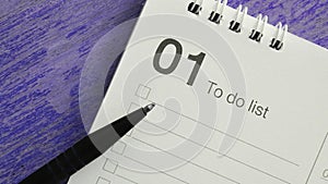 Pen on Fisrt Month To do List on Violet Background in Banner Size Image