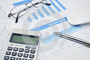 Pen and glasses on financial chart and graph, accounting background