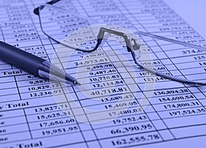 Pen and glasses on financial report