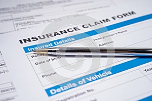 Pen on Insurance claim accident car form, Car loan, insurance and leasing time concepts