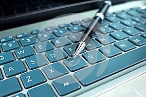 A pen on a laptop keyboard