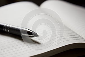 Pen laying over notebook