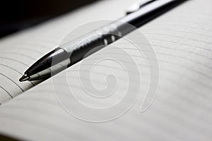 Pen laying over notebook