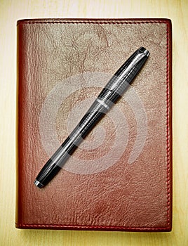 Pen on leather journal