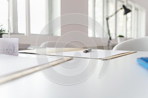 Pen lying on a document in an open folder on an office desk