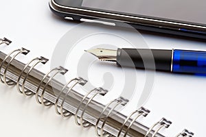 Pen, notebook and cell phone