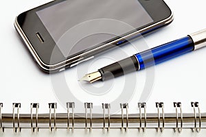Pen, notebook and cell phone