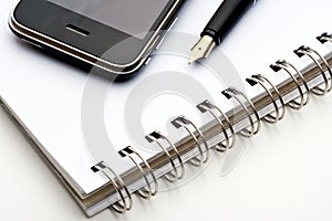 Pen, notebook and cell phone