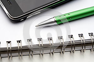 Pen, notebook and cell phone