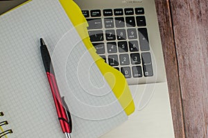 Pen and notebook on laptop. copy space