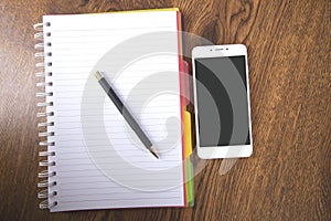 Pen with notepad and smart phone