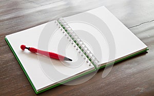 Pen and notepad on wooden table