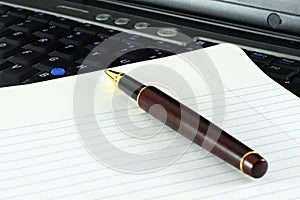 Pen, notepaper and computer keyboard