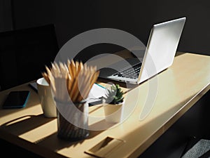 Pen , pencil set , Office workplace with laptop and smart phone on wood table, Business concept blank notebook