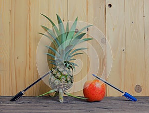 Pen-Pineapple-Apple-Pen on wooden background.