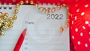 Pen Point to Blank Plans List on Year 2022 on Red Background