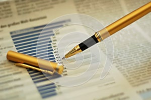 Pen showing diagram on financial report