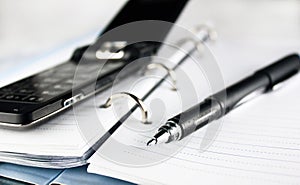 Pen, spiral notebook and cell phone