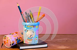 Pen stand with diary with pink background
